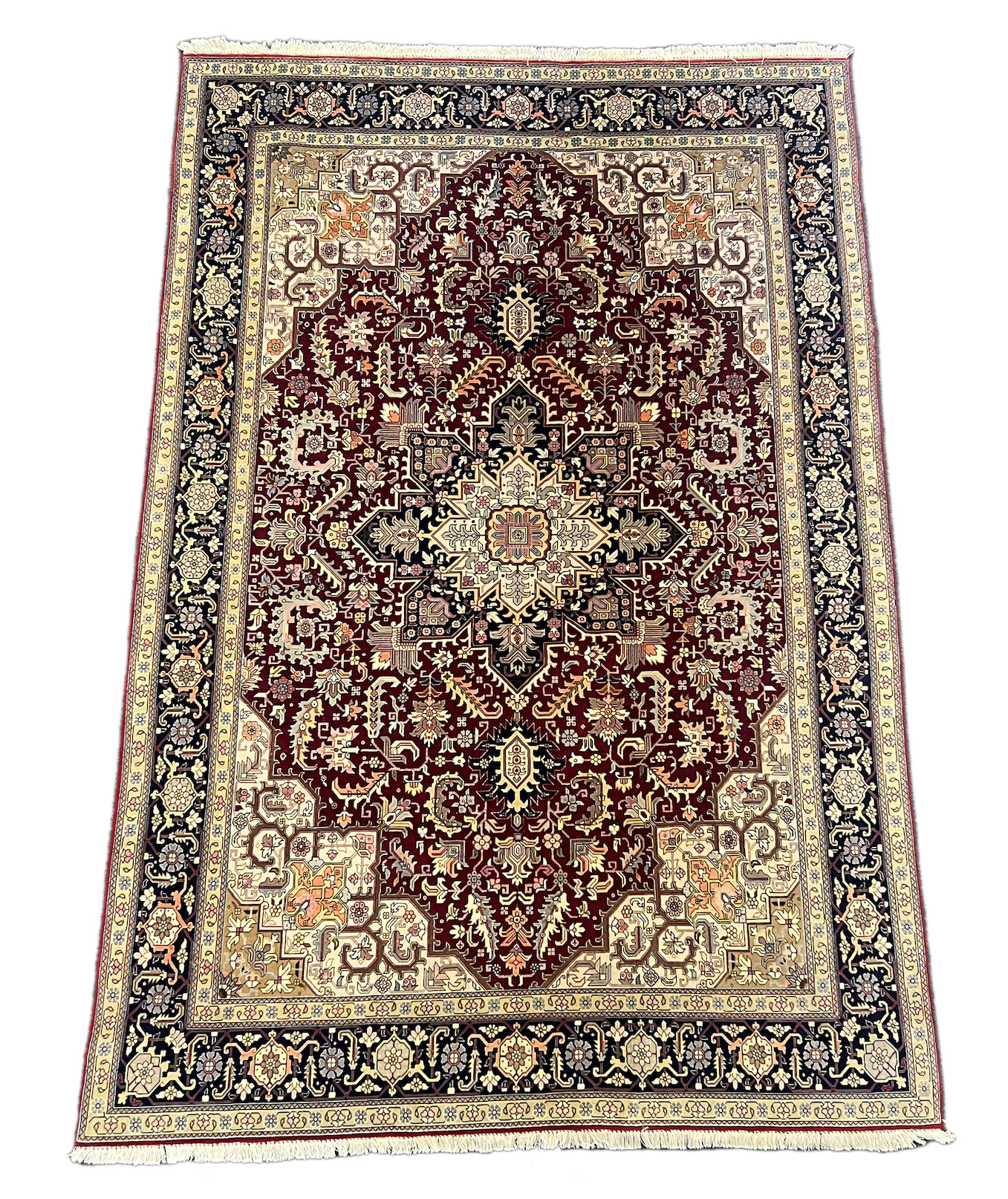 A Tabriz part silk burgundy ground carpet